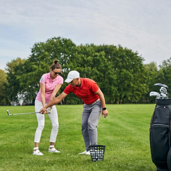 Smiling lady golfer mastering the golf basics